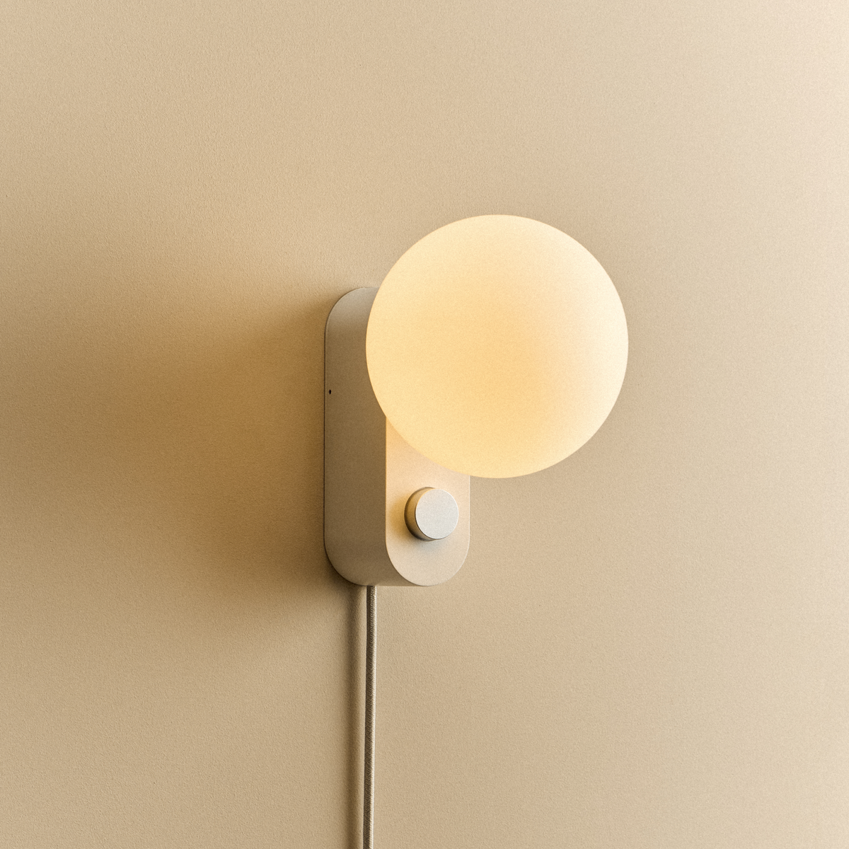 Alumina Lamp in Chalk mounted on a wall, lit