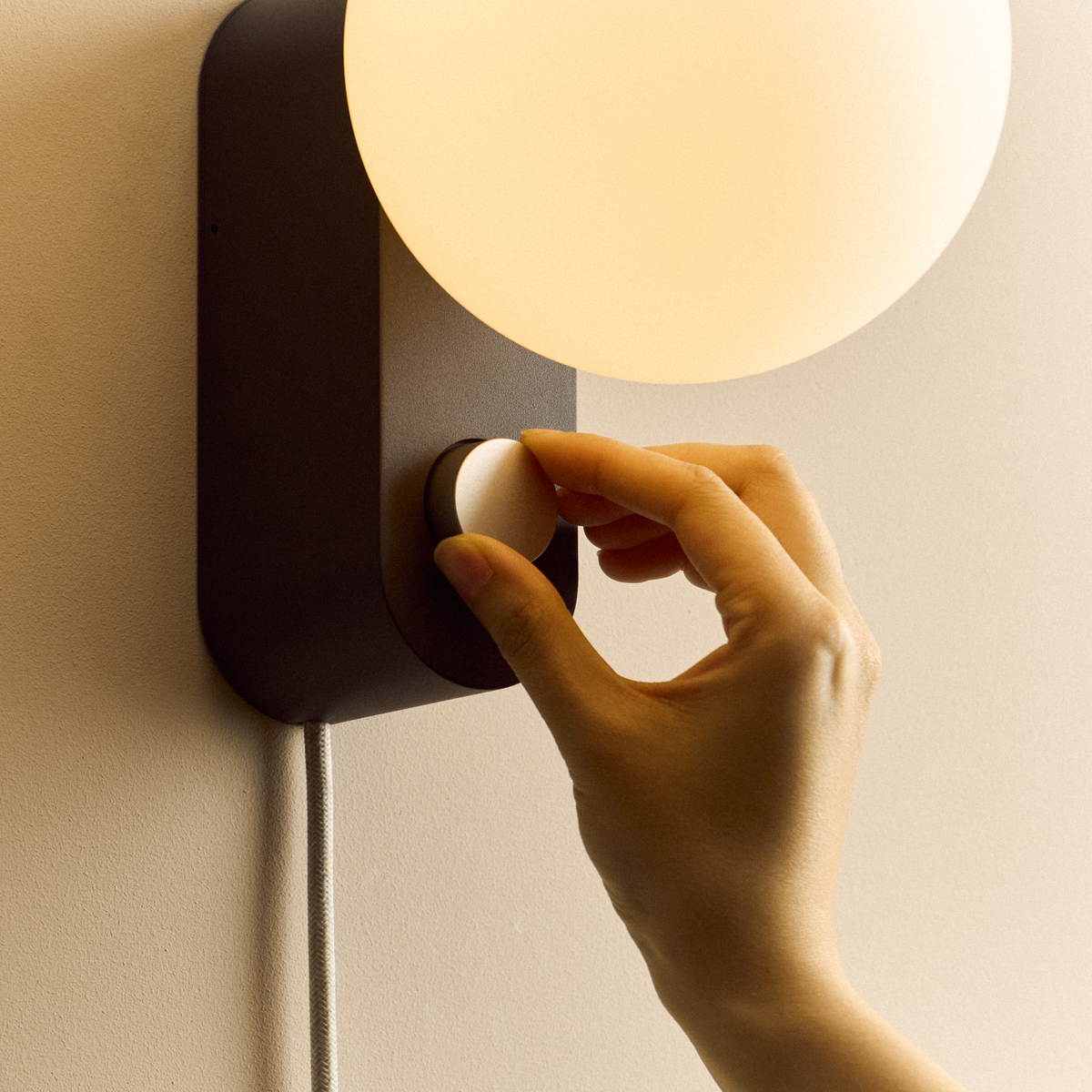 Alumina Lamp in Charcoal mounted on a wall, close-up