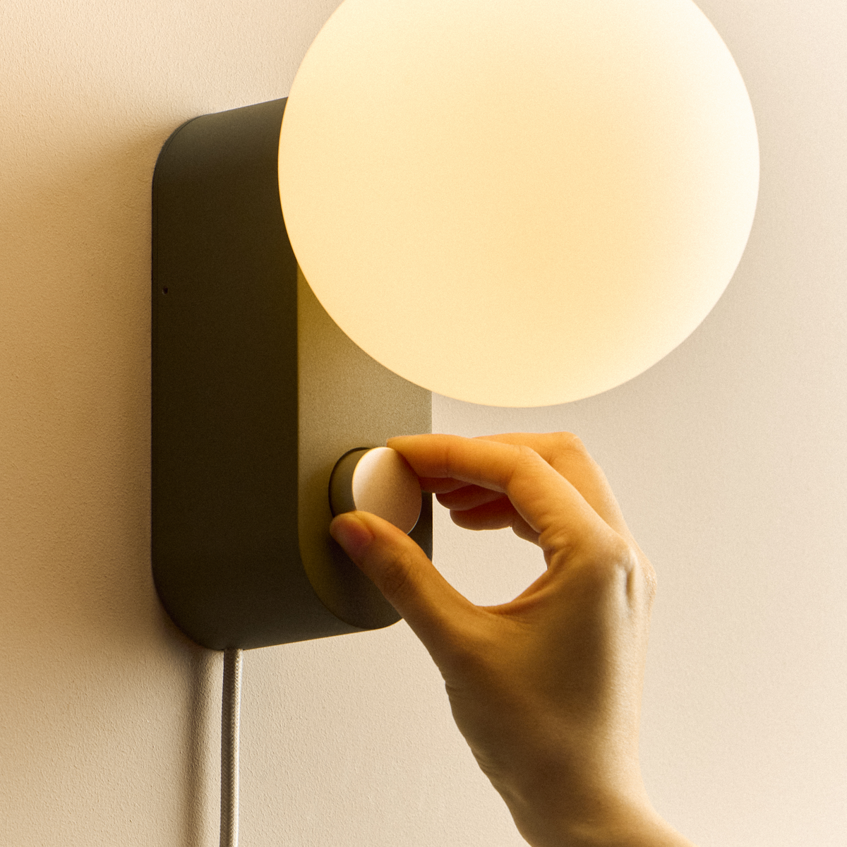 Alumina Lamp in Sage mounted on a wall, close-up