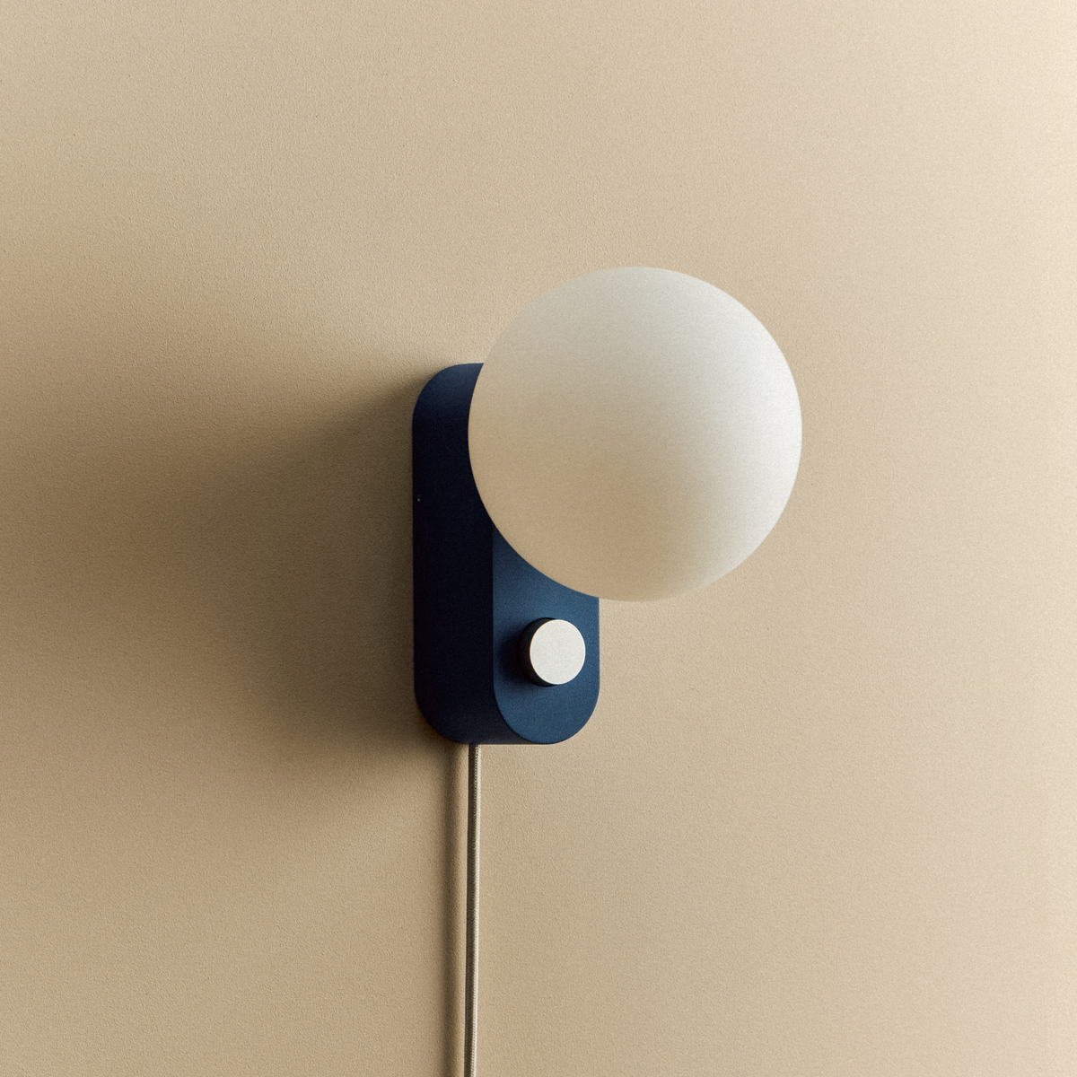 Alumina Lamp in Sapphire mounted on a wall, unlit