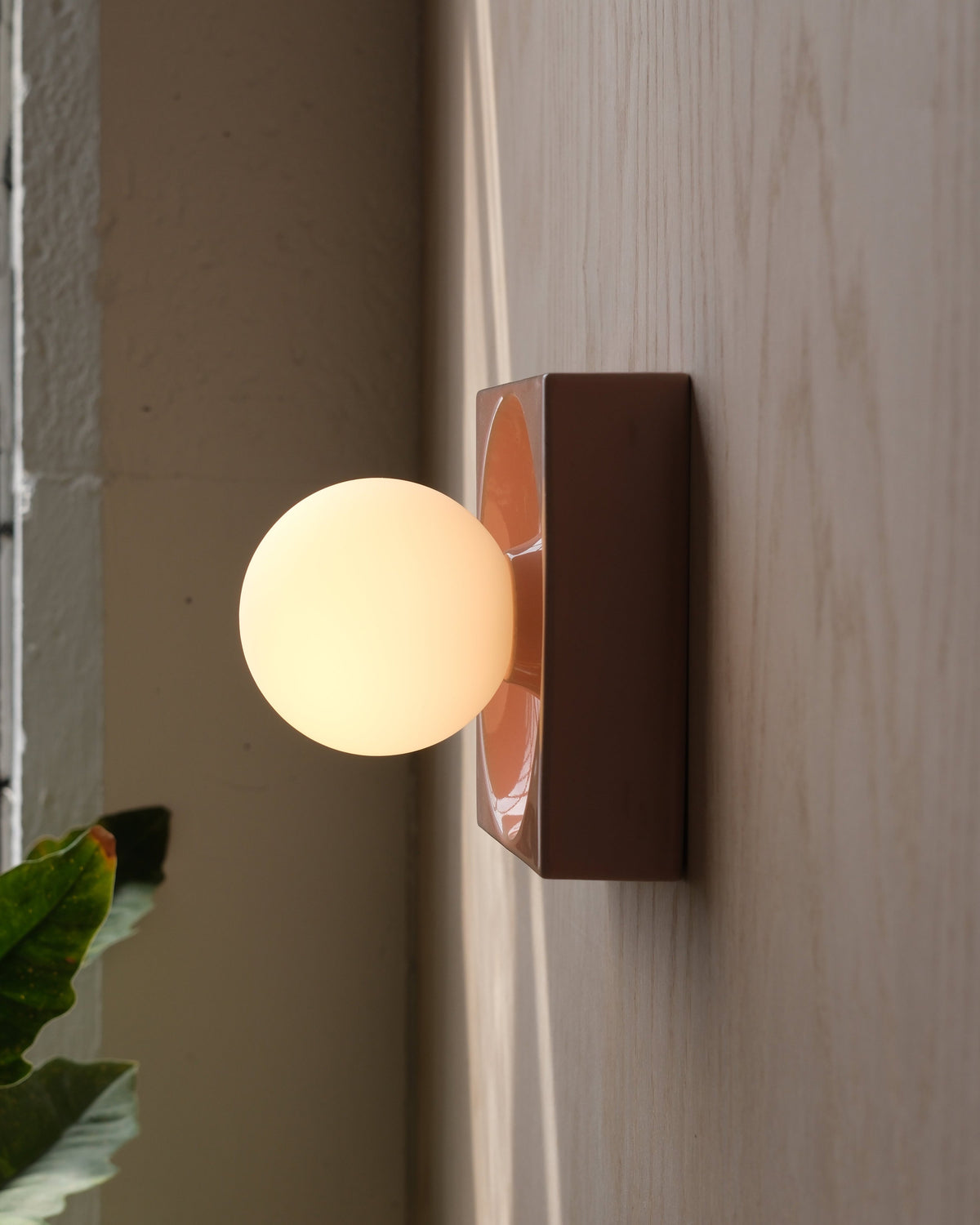 Cubic Sconce in Pink Glossy, lit, side view