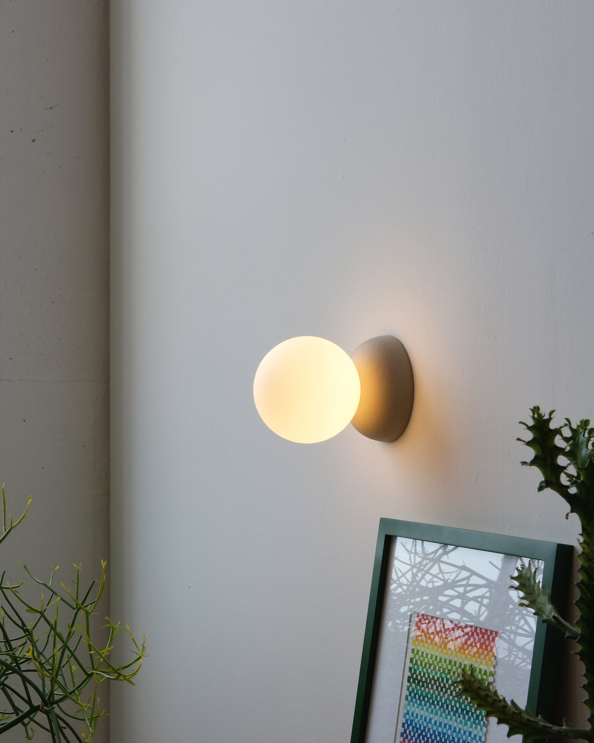 Monroe Sconce in Dune, lit, room setting