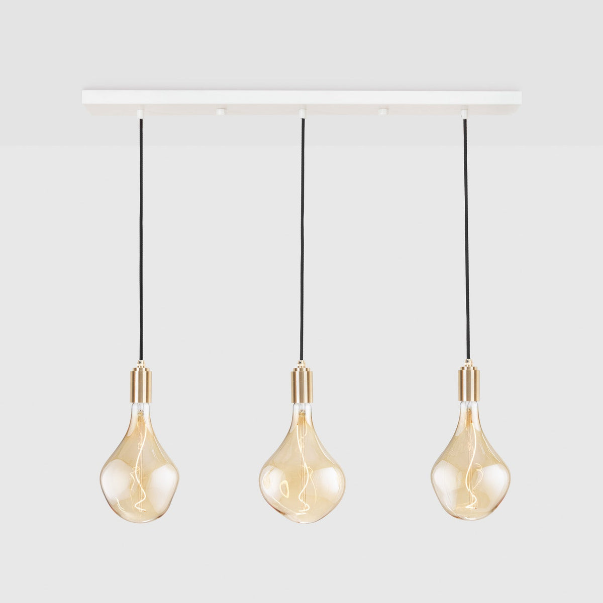 Voronoi II Linear Triple Pendant in Brass on a grey background
