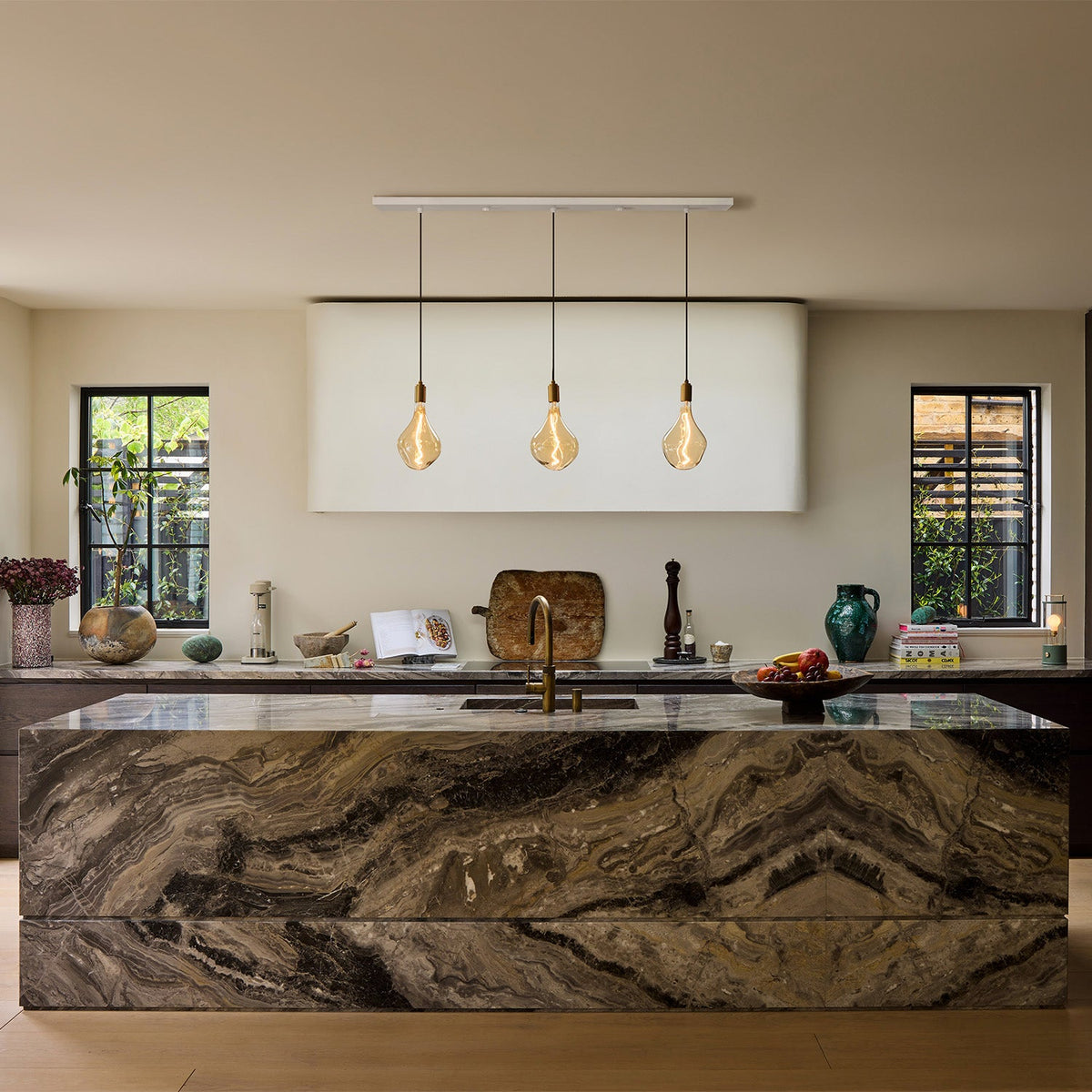 Voronoi II Linear Triple Pendant in Brass over a marble kitchen island
