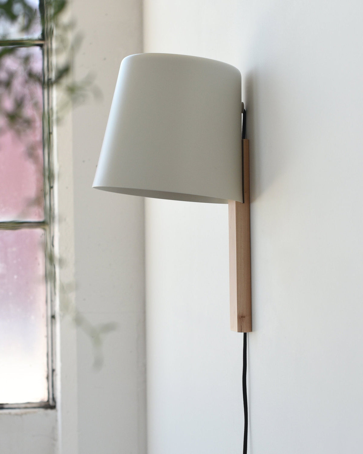 Pilot Sconce beside a window