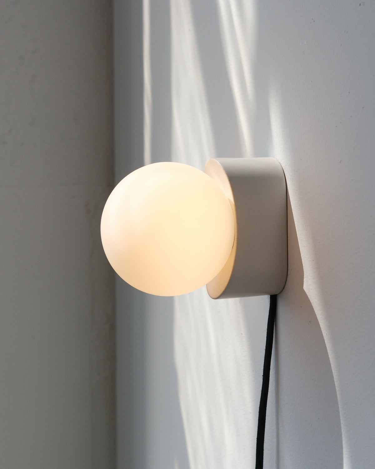 Iota Sconce in White Matte, lit