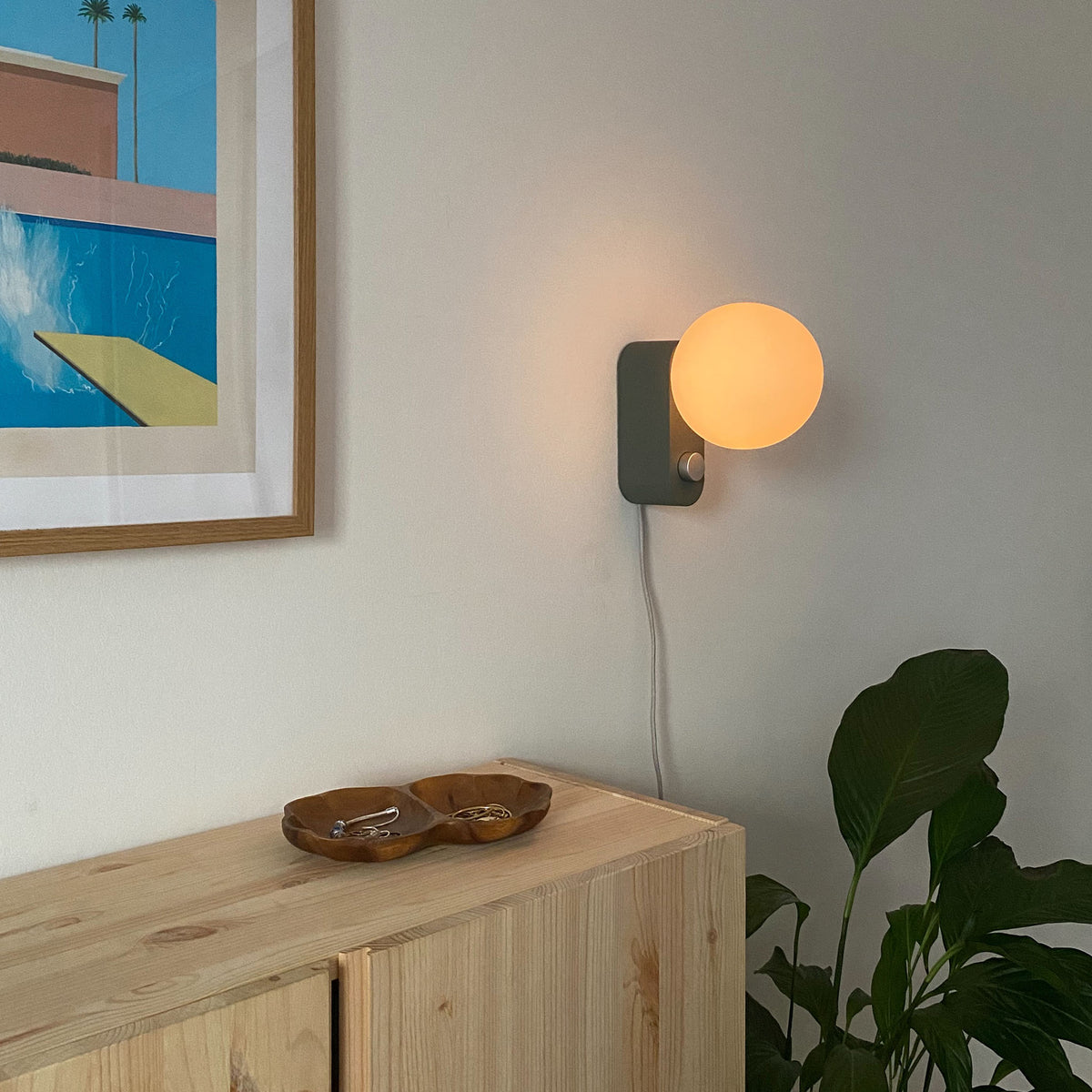 Alumina Lamp in Sage mounted on a hallway wall