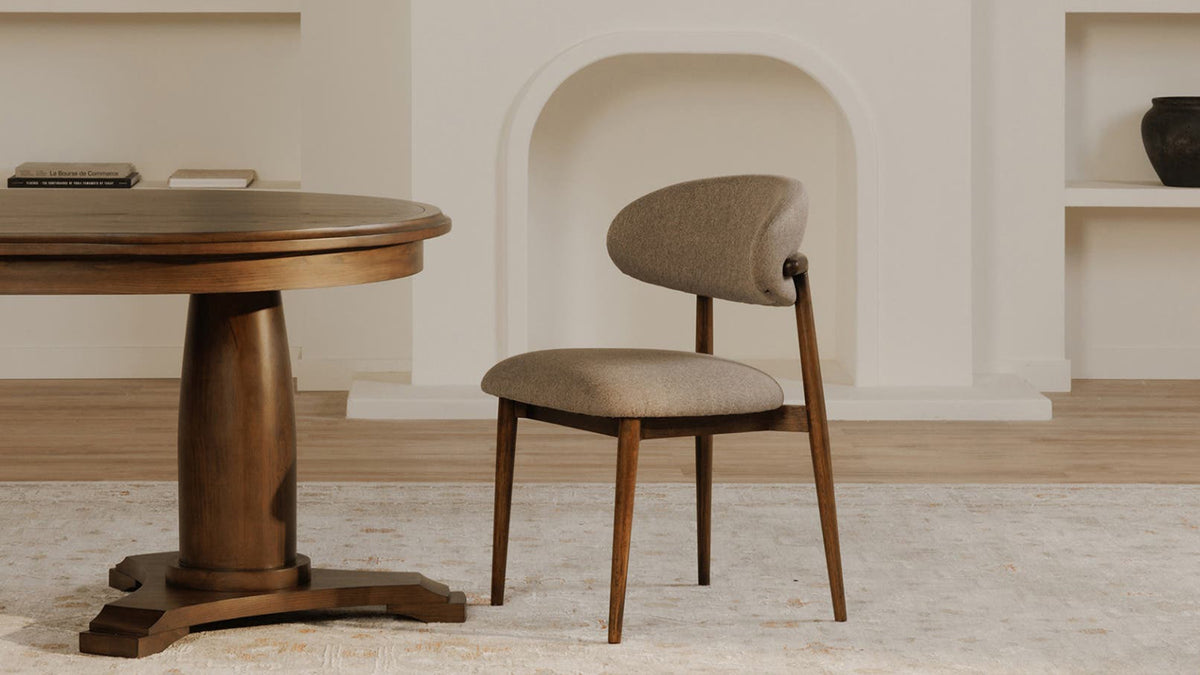 A single Moe's Home Collection Ellie dining chair in light brown performance fabric beside a round pedestal table, its winged backrest and dark espresso rubberwood frame seen from the side