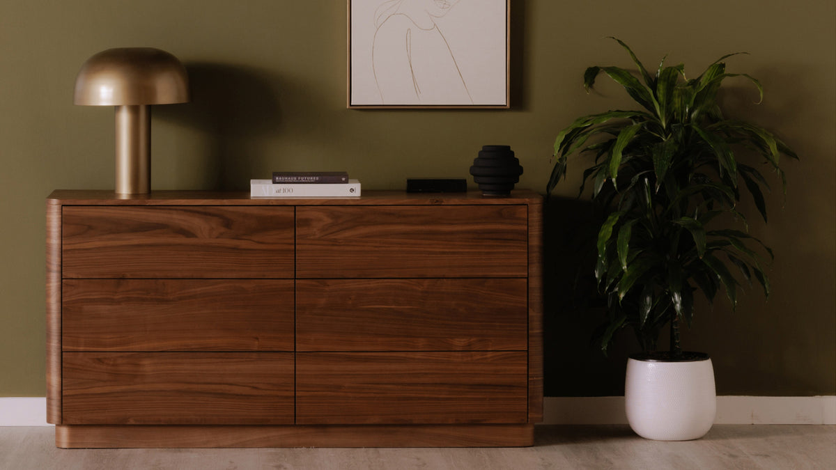 Moe's Home Collection Round Off dresser in walnut against a bedroom wall, styled with a lamp and objects on its top