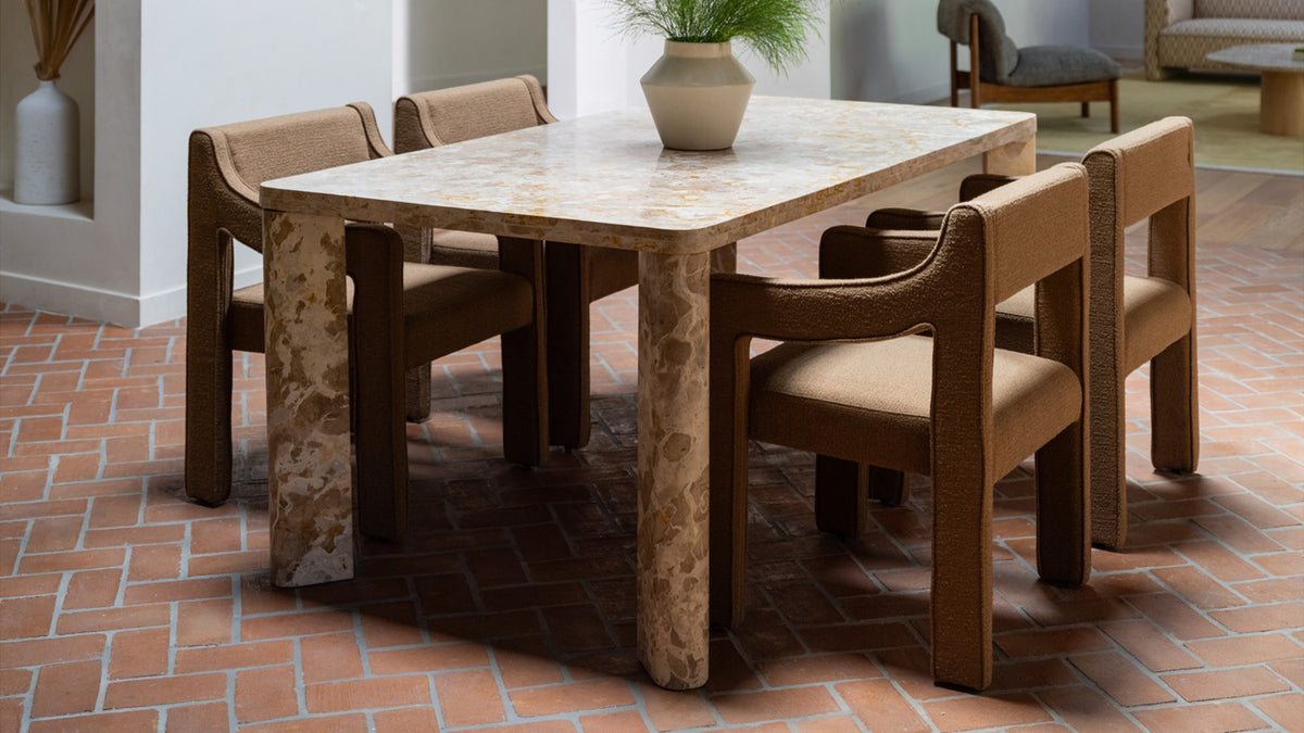 Closer view of the Segment dining table in Panther marble, showing the striations running across the top and the rounded outer face of a leg meeting its flat cut side