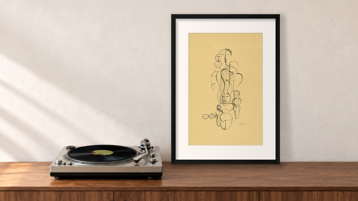 Figure Plan K1 Framed Print in a black frame, leaning on a walnut console beside a turntable