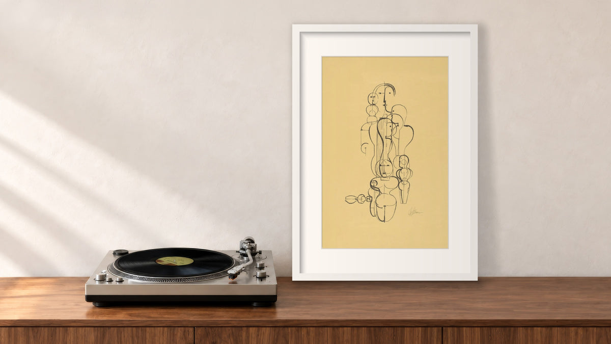Figure Plan K1 Framed Print in a white frame, leaning on a walnut console beside a turntable