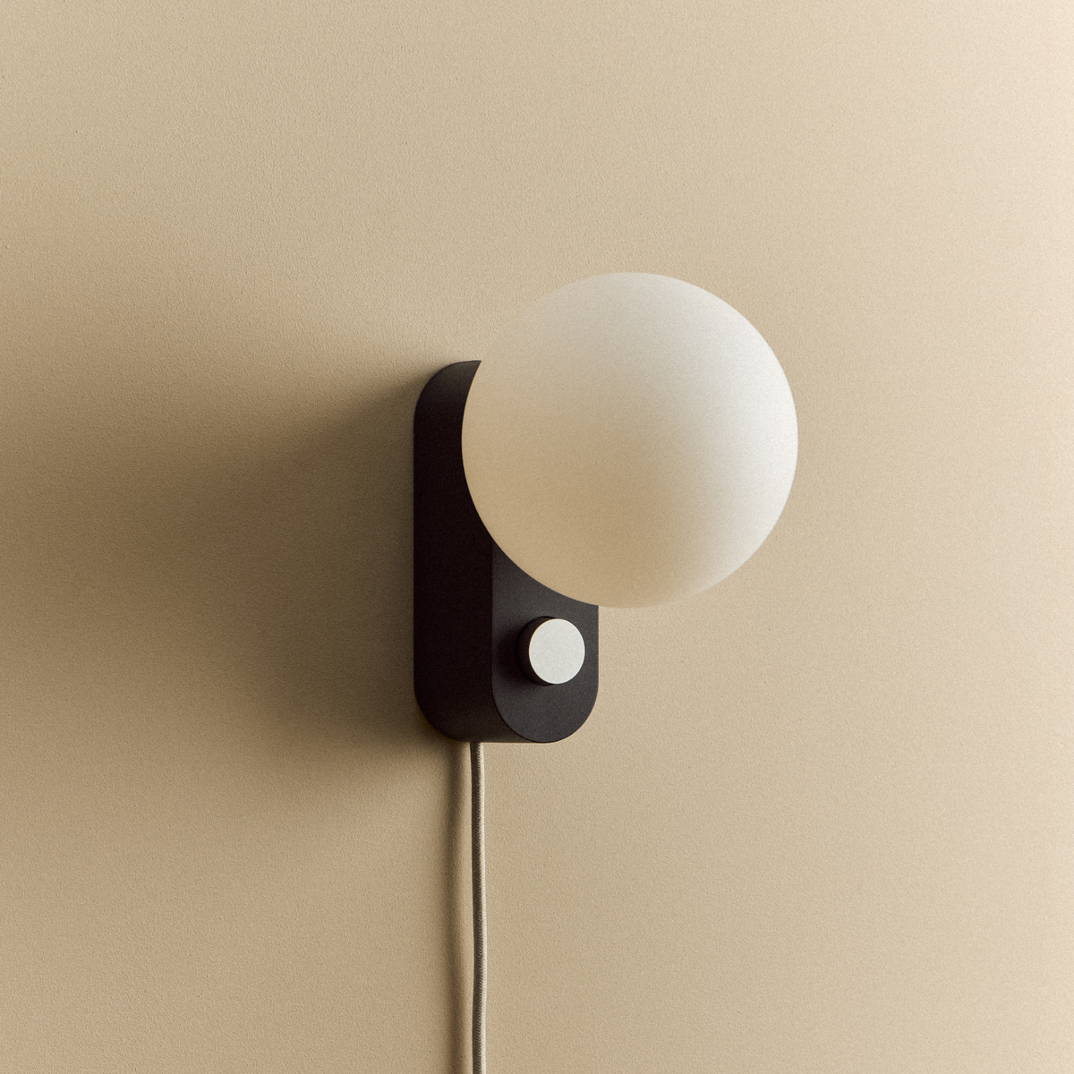 Alumina Lamp in Charcoal mounted on a wall, unlit