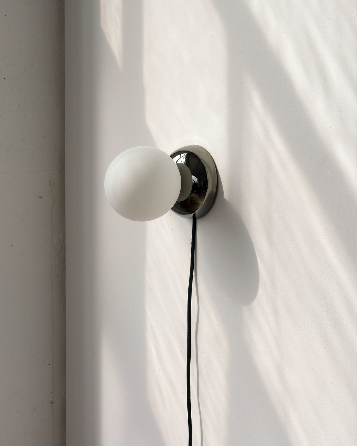 Ripple I Sconce in Chrome with its plug-in cord