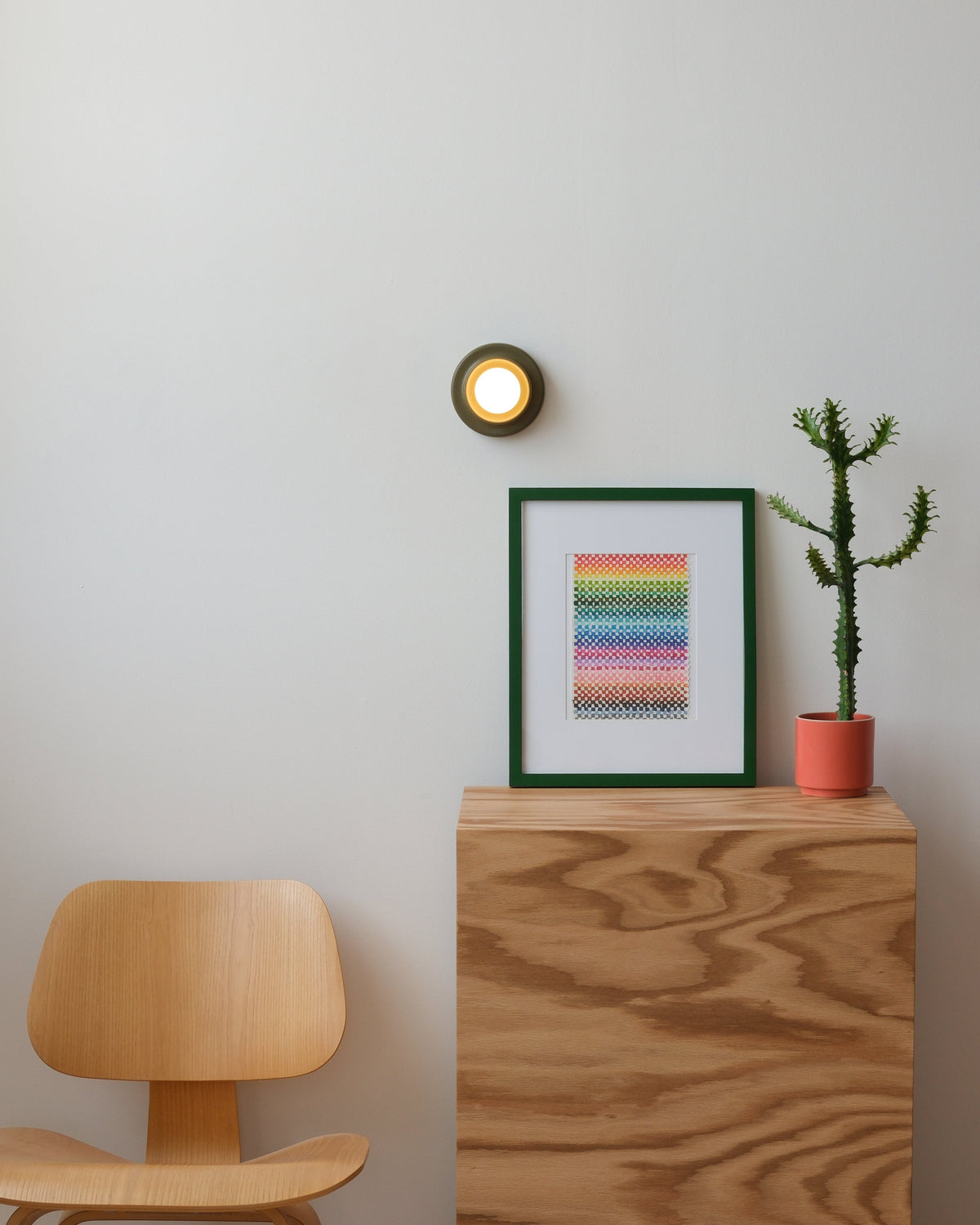 Q Sconce above a plywood cabinet, room setting