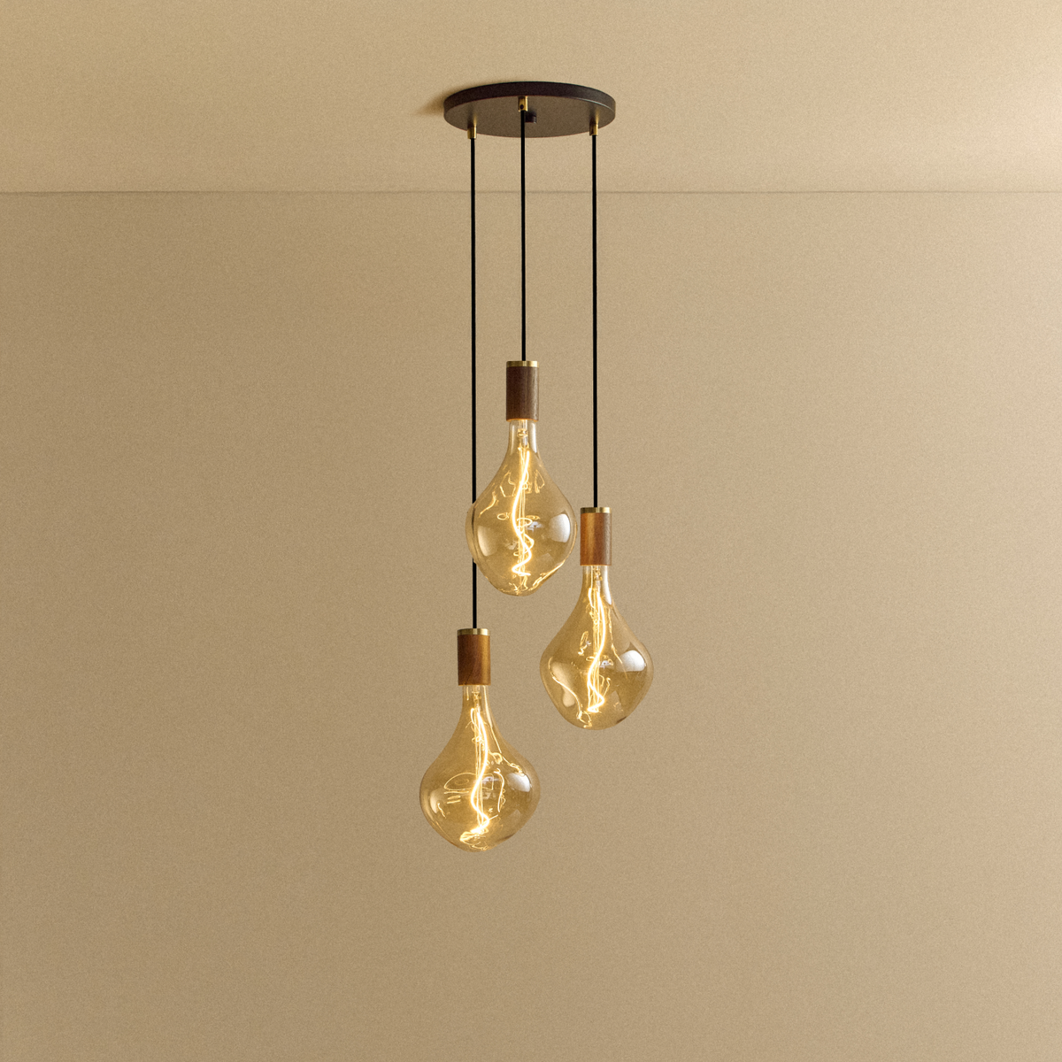 Voronoi II Triple Pendant in Walnut by Tala with a black canopy, switched on