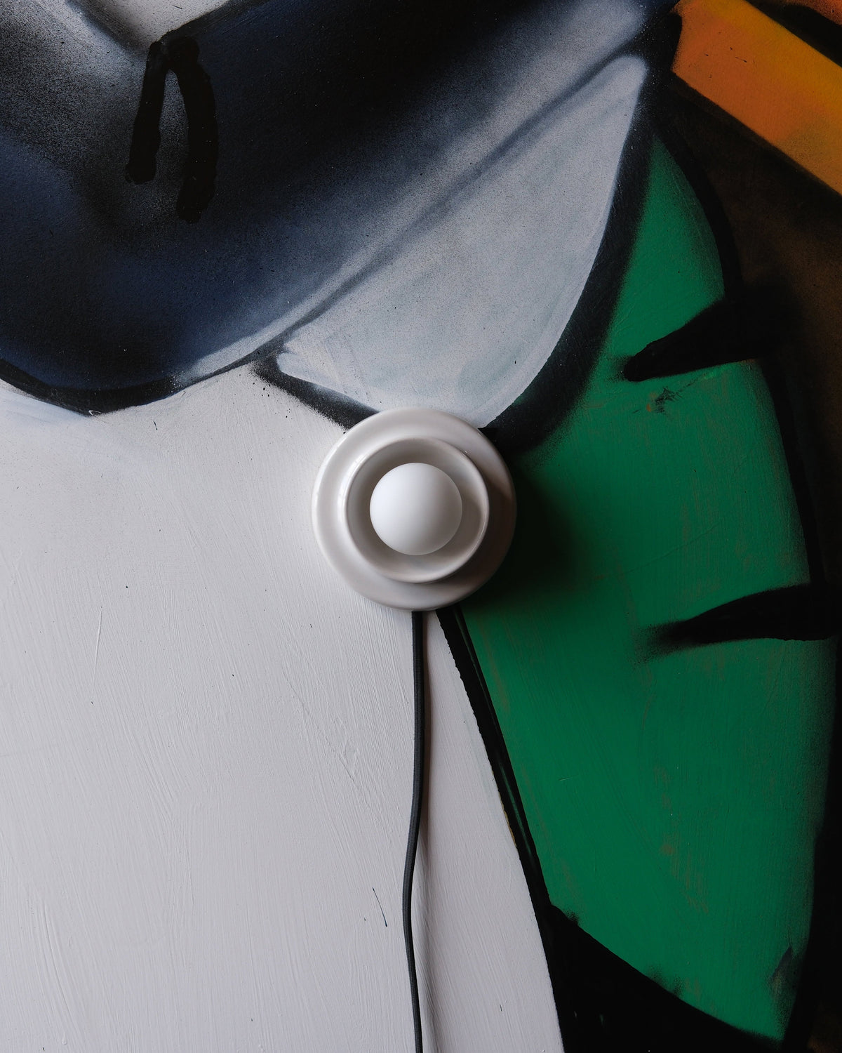 Q Sconce in White Glossy on a painted mural