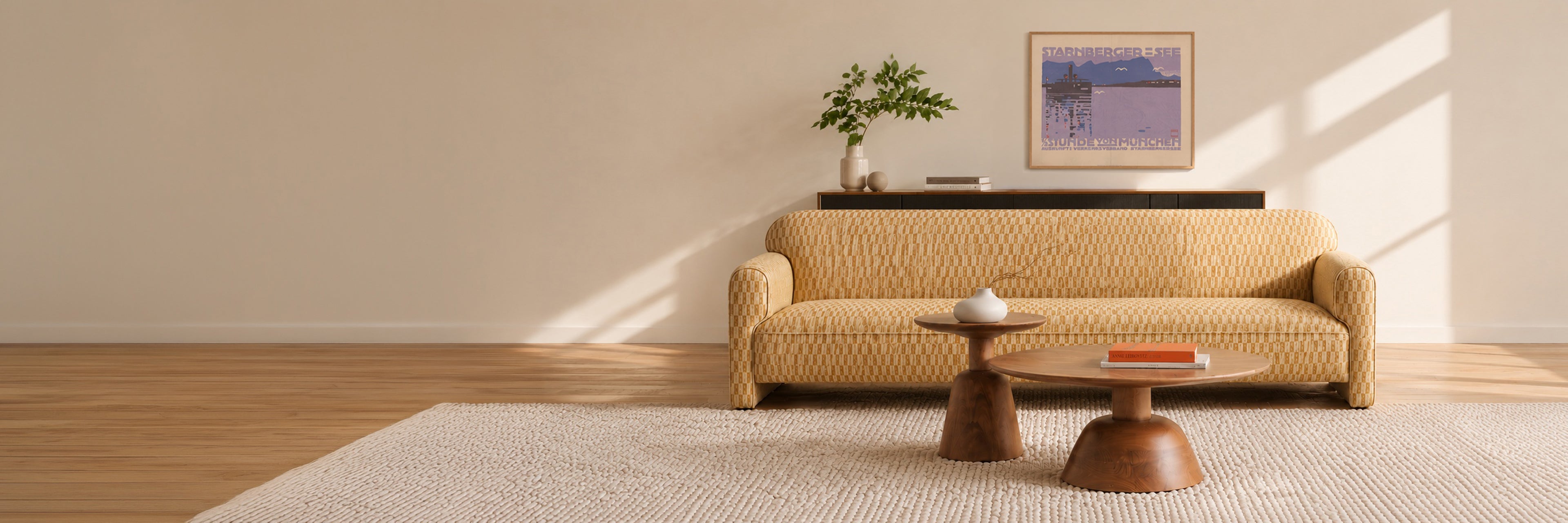 A mid-century modern sofa with chartreuse, geometric fabric in a styled living room setting with wooden coffee tables, a textured rug, and a framed poster on the wall.