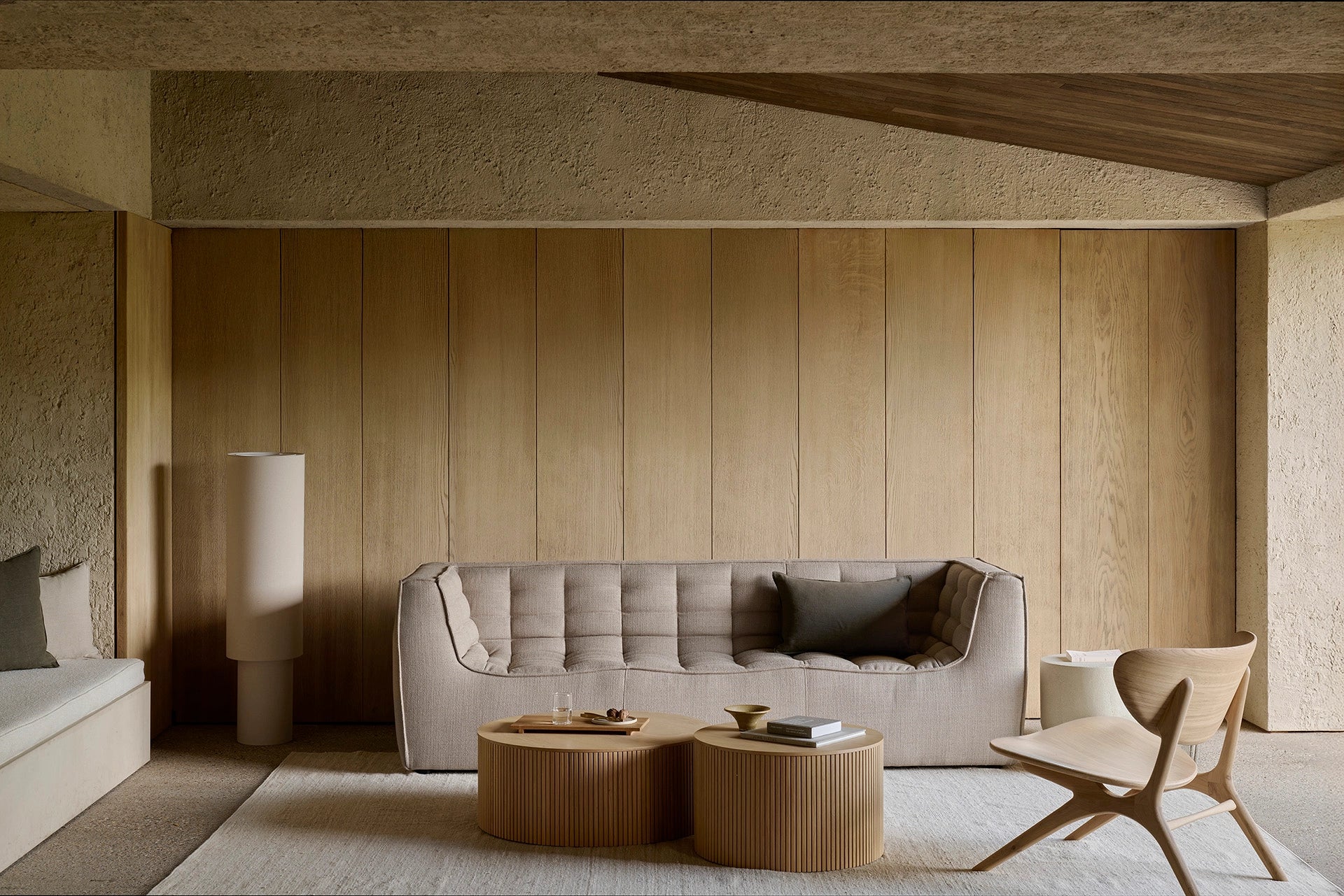 Modern living room with a gray sofa, wooden coffee table, and decorative items.