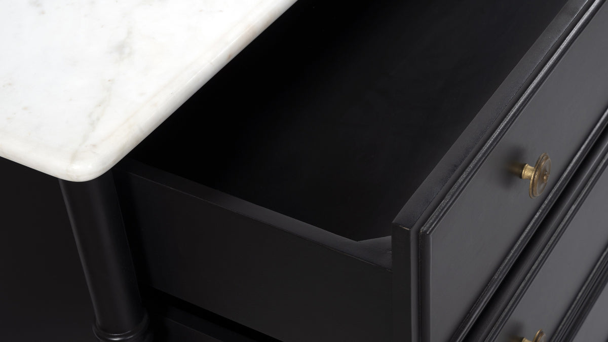 Detail of the Moe's Home Collection Eleanor 6 Drawer Dresser: the white Banswara marble top, an open drawer and an antique brass handle