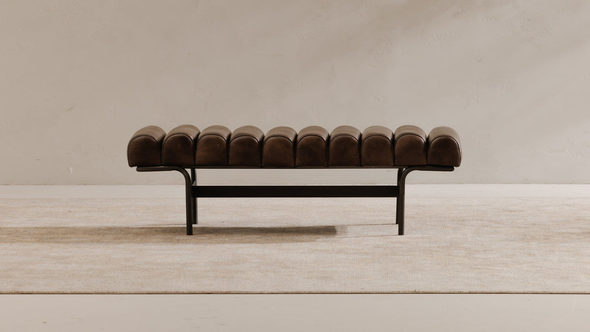 Moe's Home Collection Harrison bench in dark brown top-grain buffalo leather on a black iron frame, against a pale plaster wall