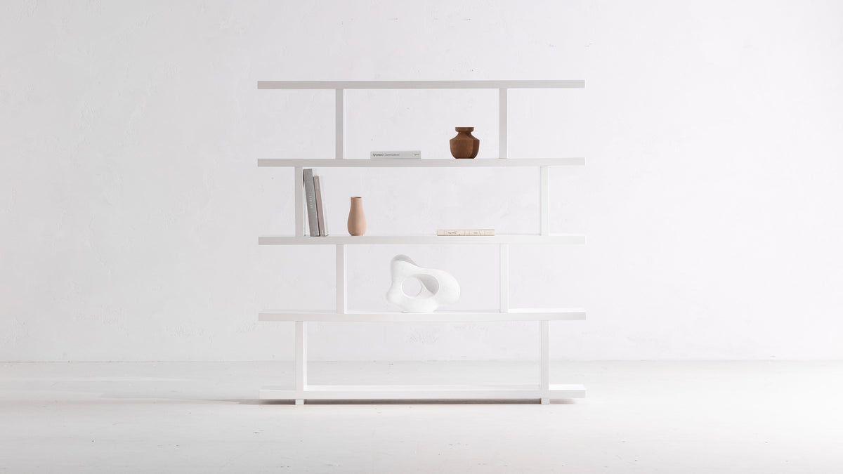 Moe's Home Collection Miri Large bookshelf in high-gloss white, five stepped planks against a white wall with a terracotta vase, books and a white sculptural form