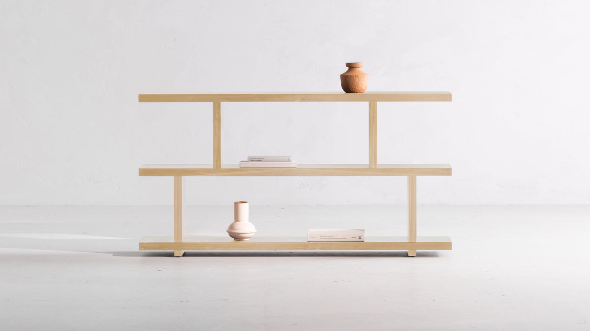 Moe's Home Collection Miri Small bookshelf in white oak, three stepped planks with a rounded vessel above and a pale vase below