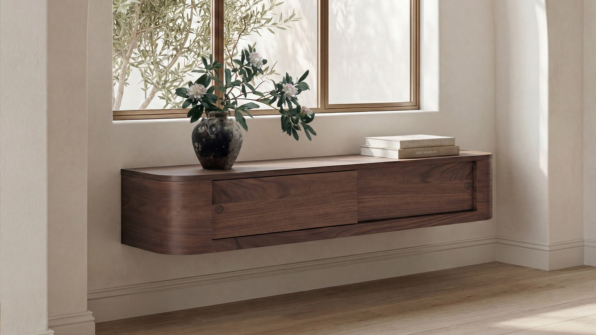 Moe's Home Collection Round Off floating console table in walnut, wall mounted beneath a window and styled with olive branches in a dark ceramic vase and a small stack of books