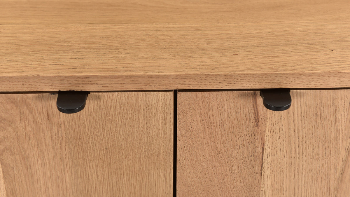 Moe's Home Collection Theo oak cabinet in natural oak, close at the top edge, where the line between the two doors and the black pulls are visible