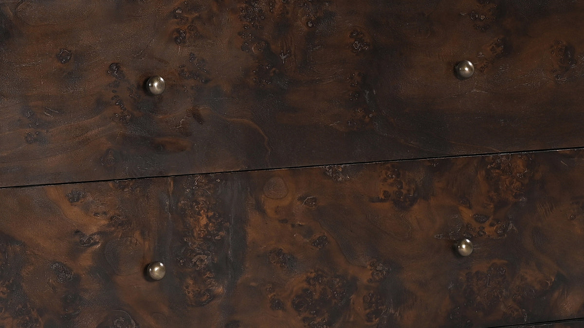 Close detail of the Moe's Home Collection York 3 Drawer nightstand, the burl figure swirling across two drawer fronts with a small round brass knob on each