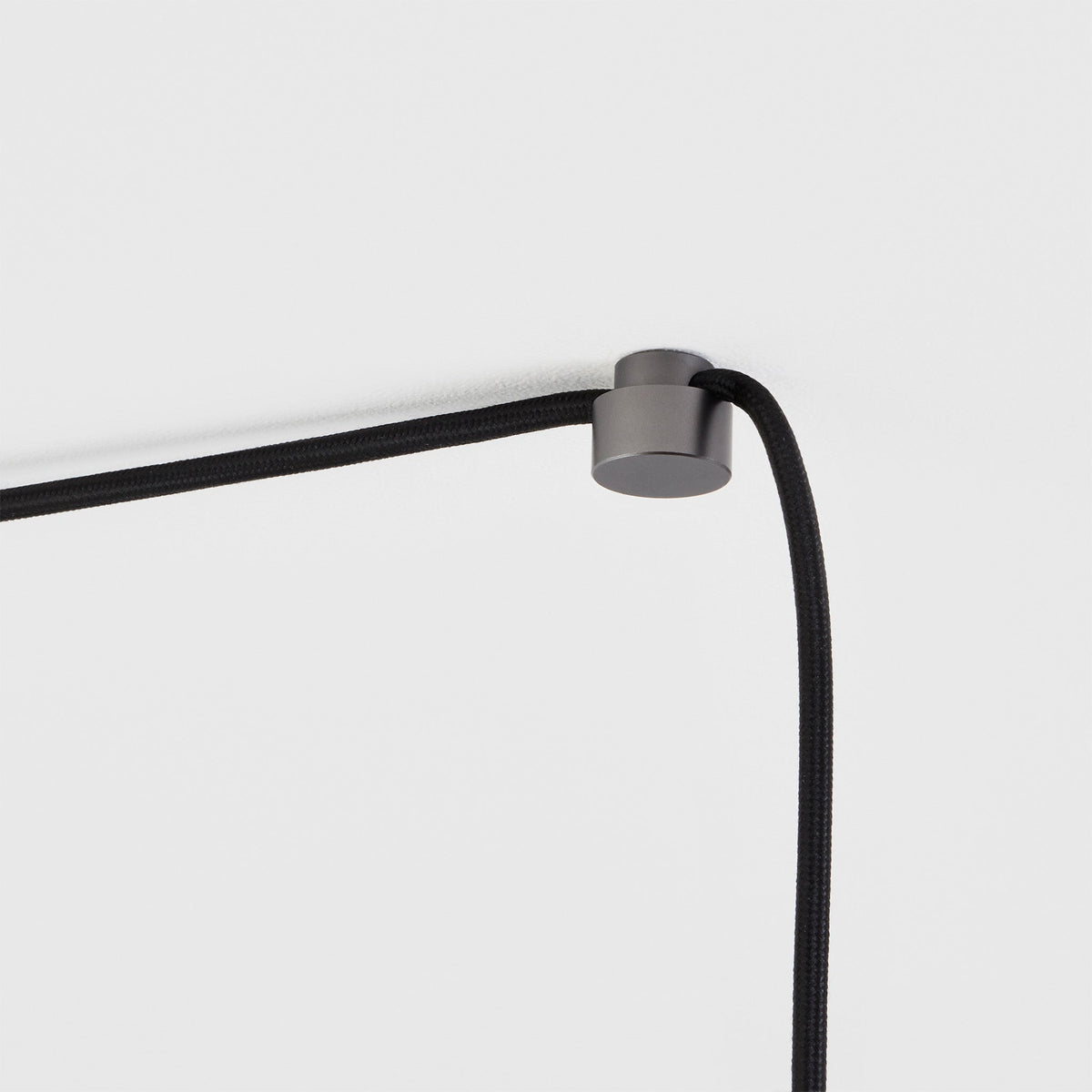 Voronoi II Plug-In Pendant, graphite ceiling node holding the cable