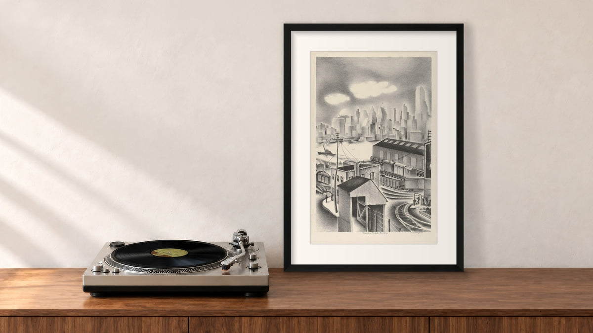 Columbia Heights, Brooklyn Framed Print in a black frame, leaning on a walnut console beside a turntable