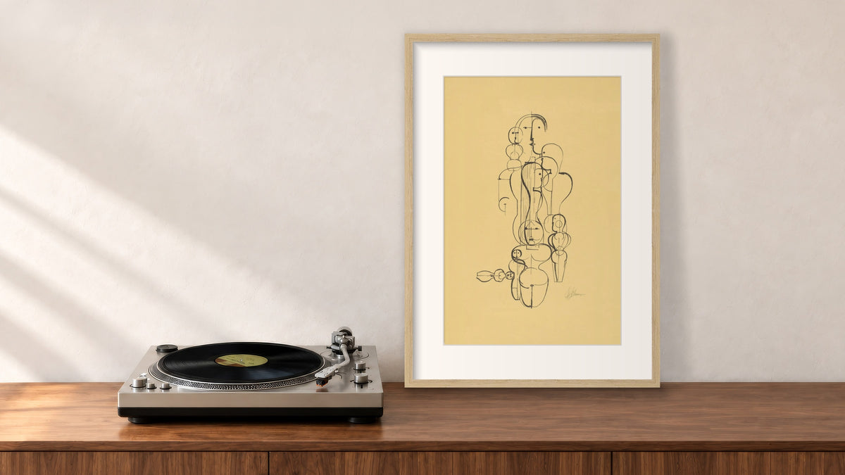 Figure Plan K1 Framed Print in an oak frame, leaning on a walnut console beside a turntable