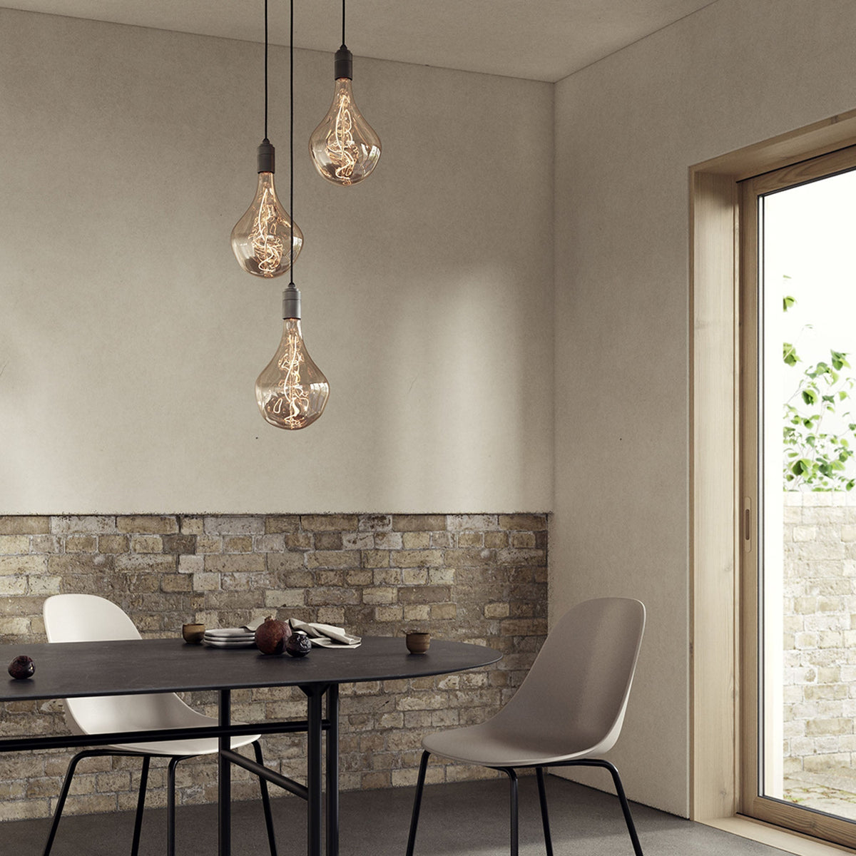 Voronoi II Triple Pendant in Graphite over a dining table